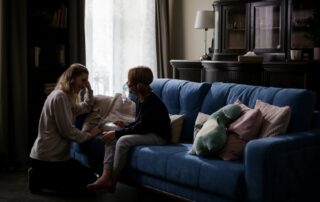 Mother helping her child use an inhaler at home, representing pediatric respiratory care during Boise's smoky summers.