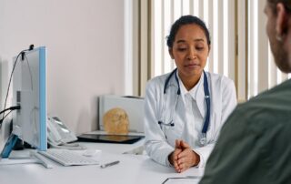 Female doctor consulting a woman patient in a modern medical office for preventive care