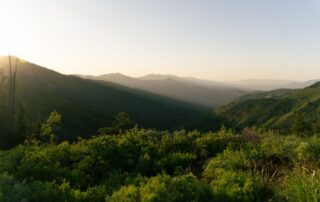 Sunrise over the Boise foothills with walking trail winding through sagebrush