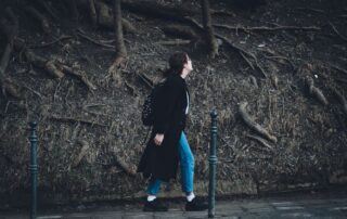 Woman walking outdoors on a sunny path, representing everyday women's health and wellness