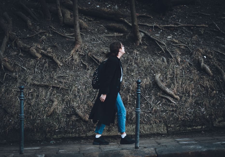 Woman walking outdoors on a sunny path, representing everyday women's health and wellness