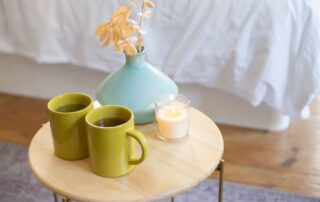 A warm mug of tea on a kitchen table, suggesting recovery from a short-term illness at home